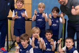 G-Jugend DJK Straubing mit Daumen hoch und Pokalen in der Hand nach erfolgreichem Hallenturnier